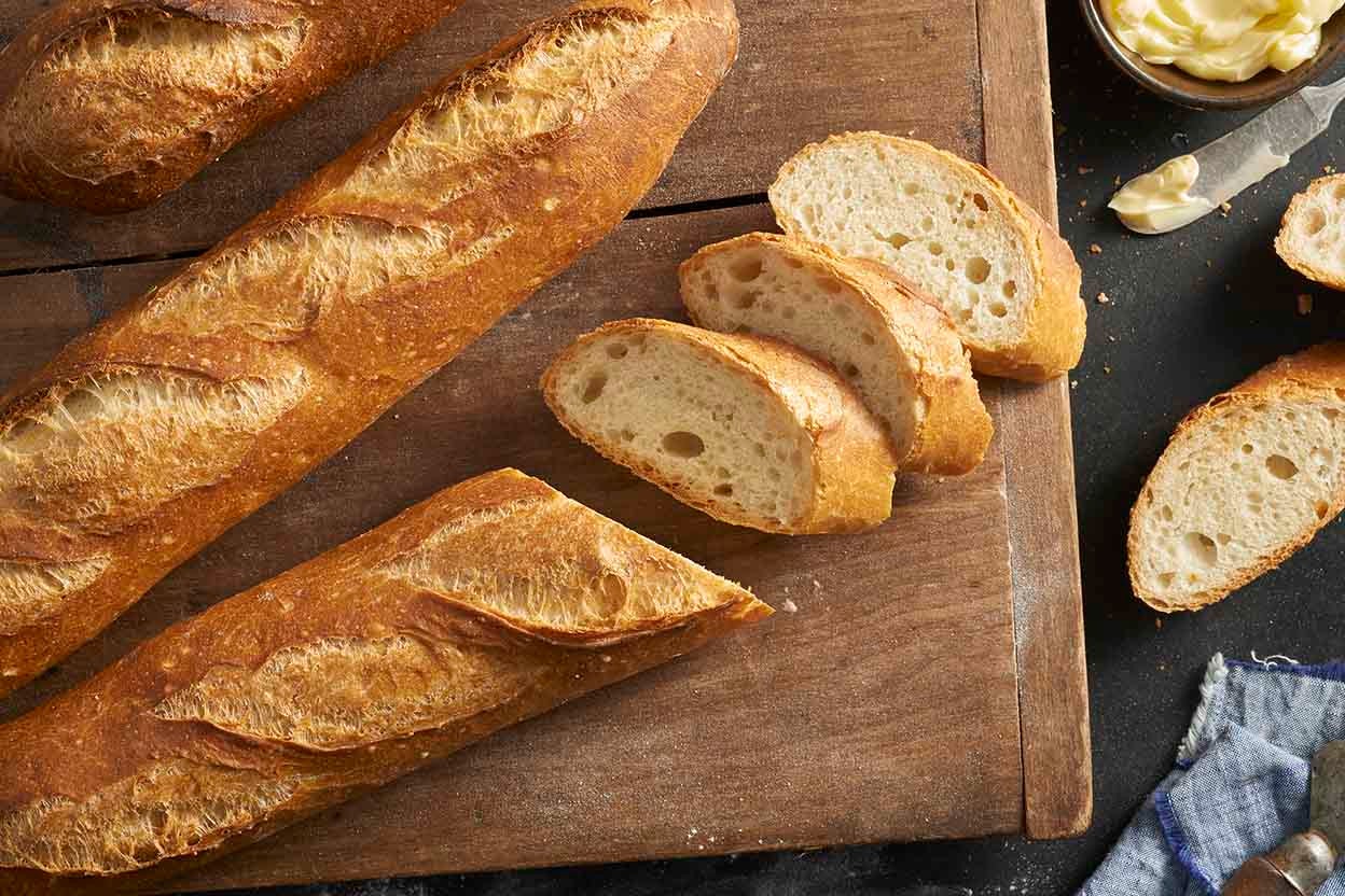 Baguette, European style bread on blue wood table in morning time