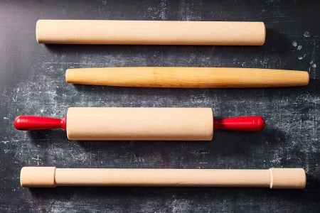 Four different styles of rolling pins next to each other