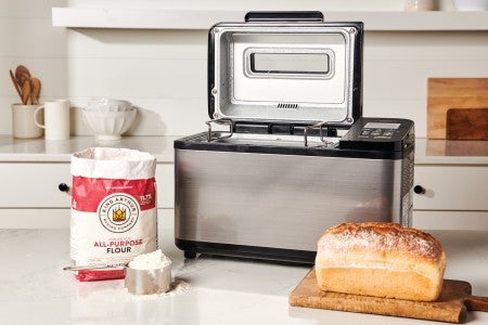 Loaf of bread in front of bread machine