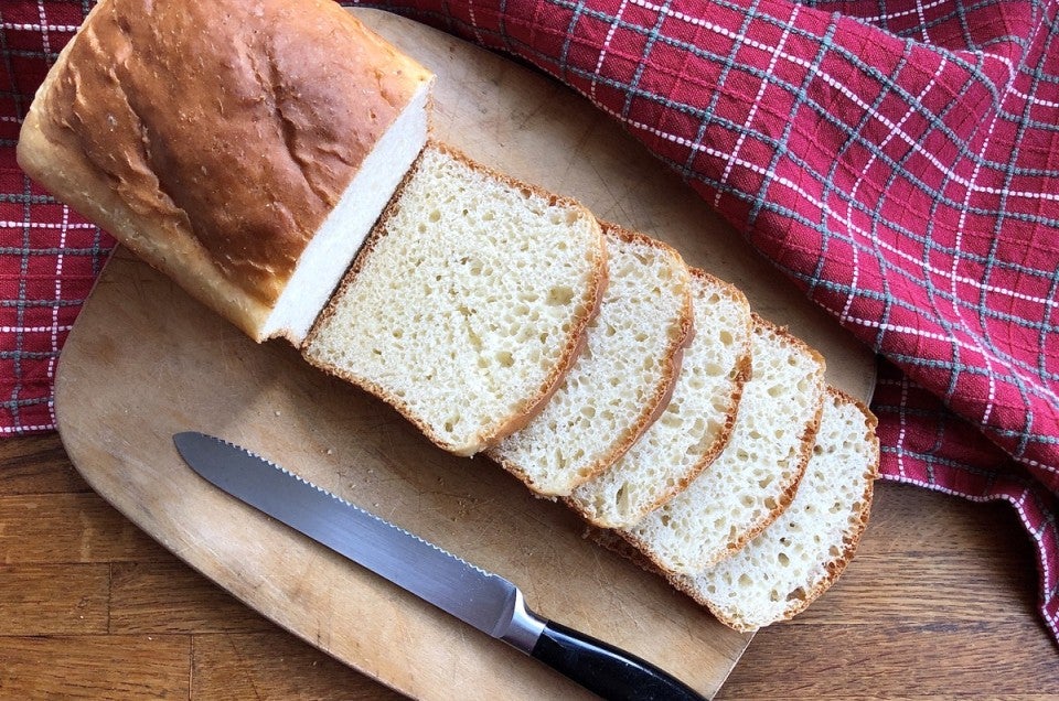 Sliced sandwich loaf on cutting board