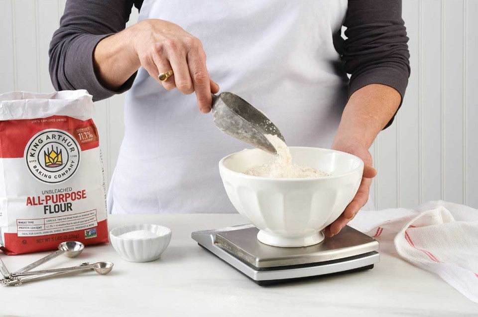 Baker weighing flour with a scale