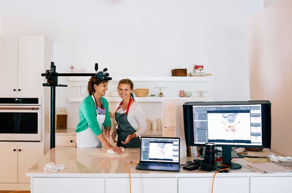 Woman and young girl baking together in studio kitchen