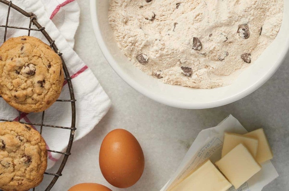 Bowl of cookie mix next to ingredients