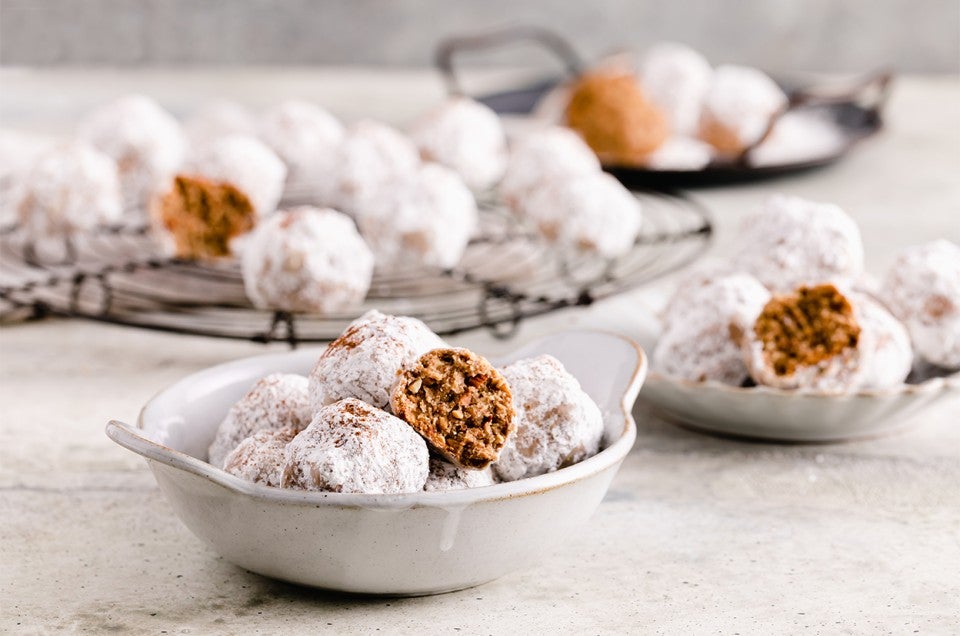 A bowl of Horchata Polvorones with some on a cooling rack in the background - select to zoom