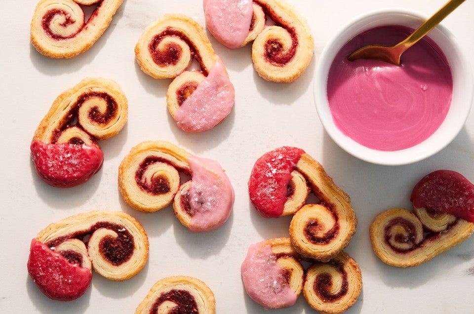 Mini raspberry palmiers dipped in pink raspberry glaze