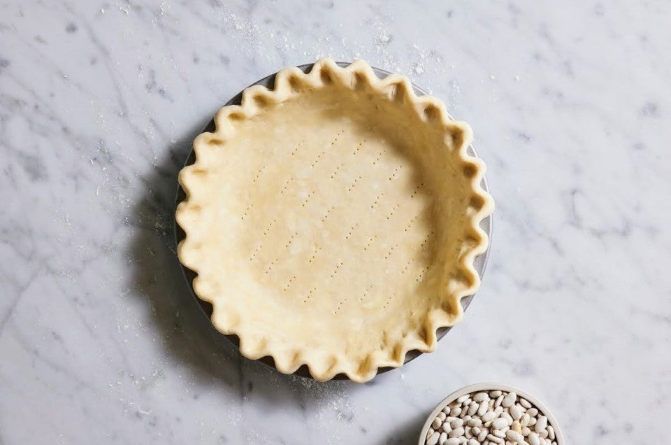 Pie crust rolled out, docked, crimped, in the pan and ready to be filled.