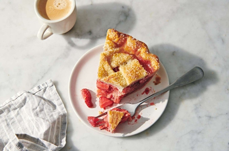 Slice of pie with a piece overturned to show golden brown bottom