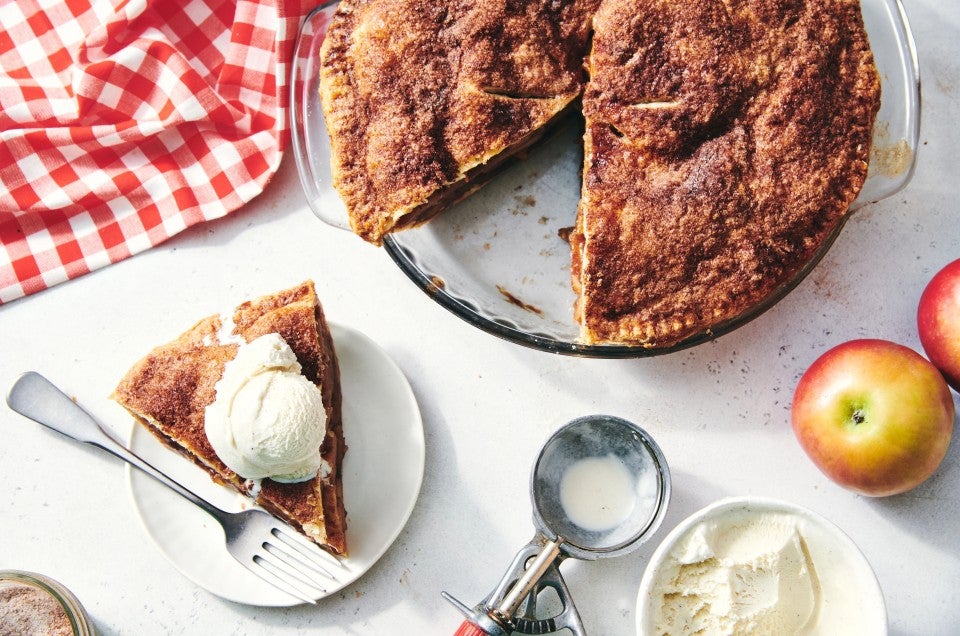 cinnamon and apple sugar pie with a slice taken out on a plate