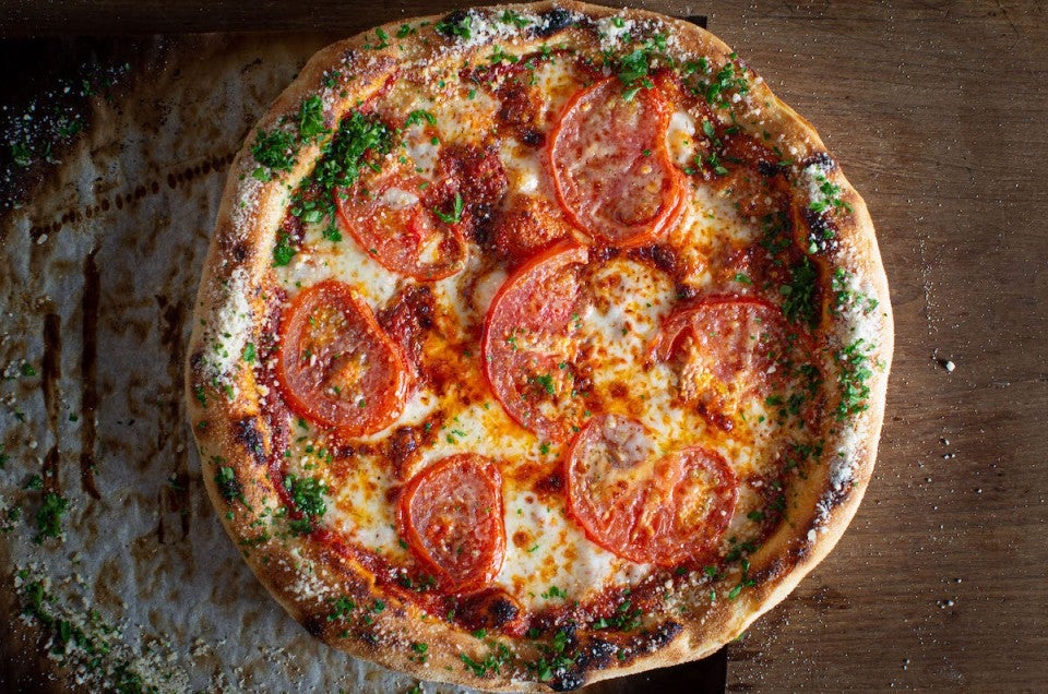 Pizza with garlic butter, Parmesan, and herb crust