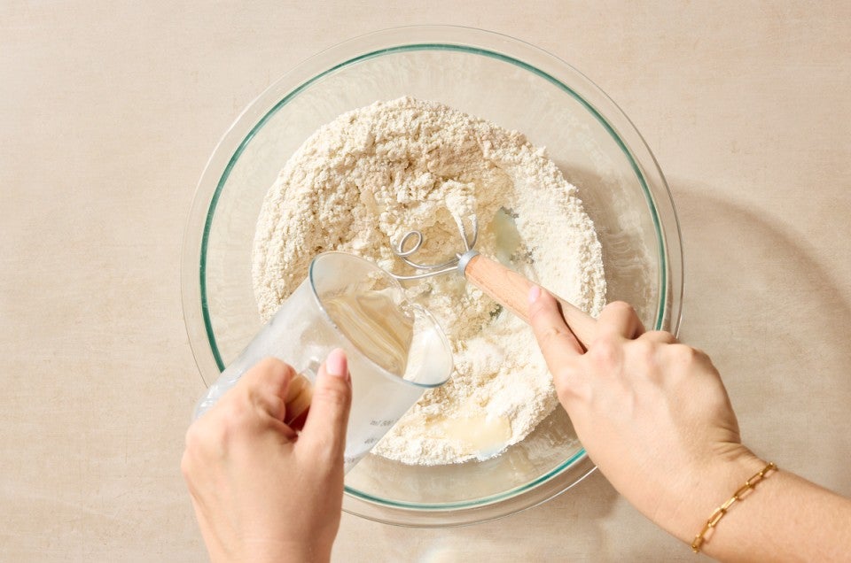 Boiling water being poured into flour