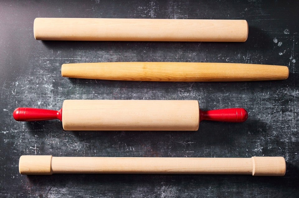 Four different styles of rolling pins next to each other