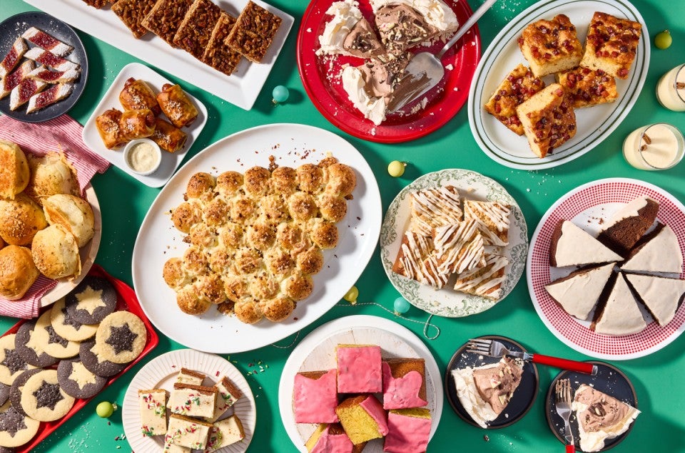 Multiple different holiday recipes plated on a green background