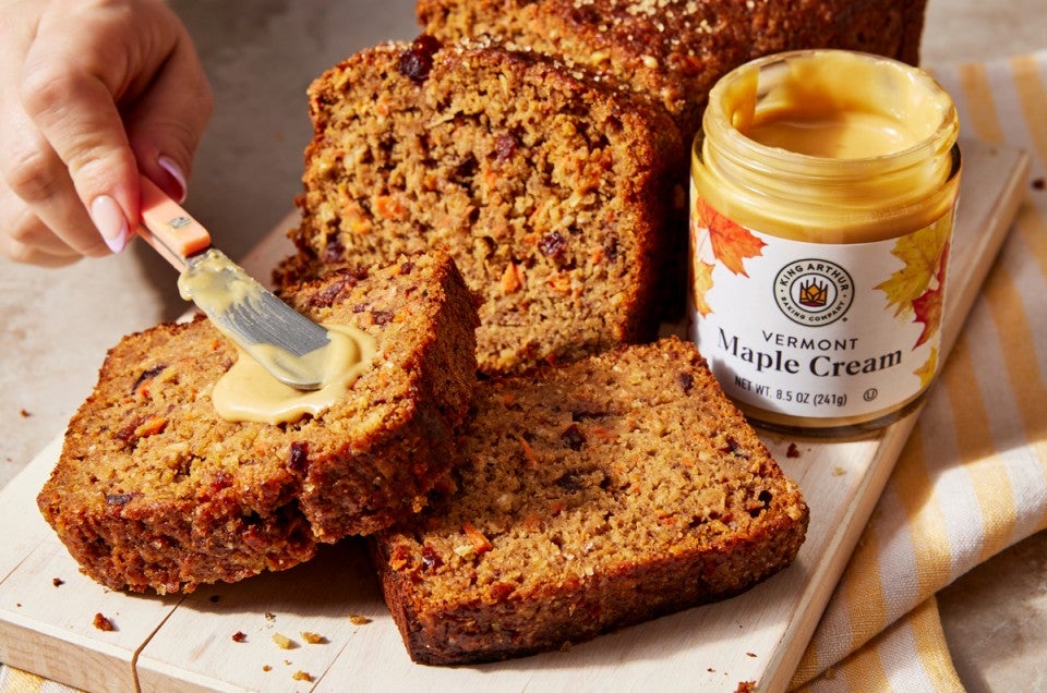 Maple cream being spread on quick bread