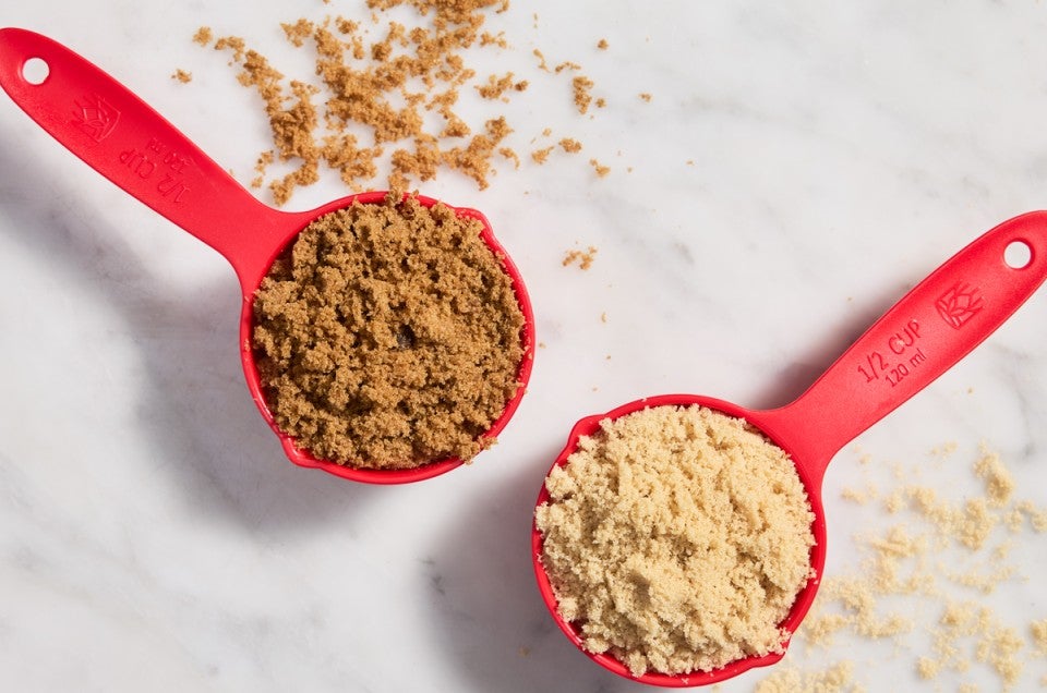 Dark brown sugar and light brown sugar in measuring cups