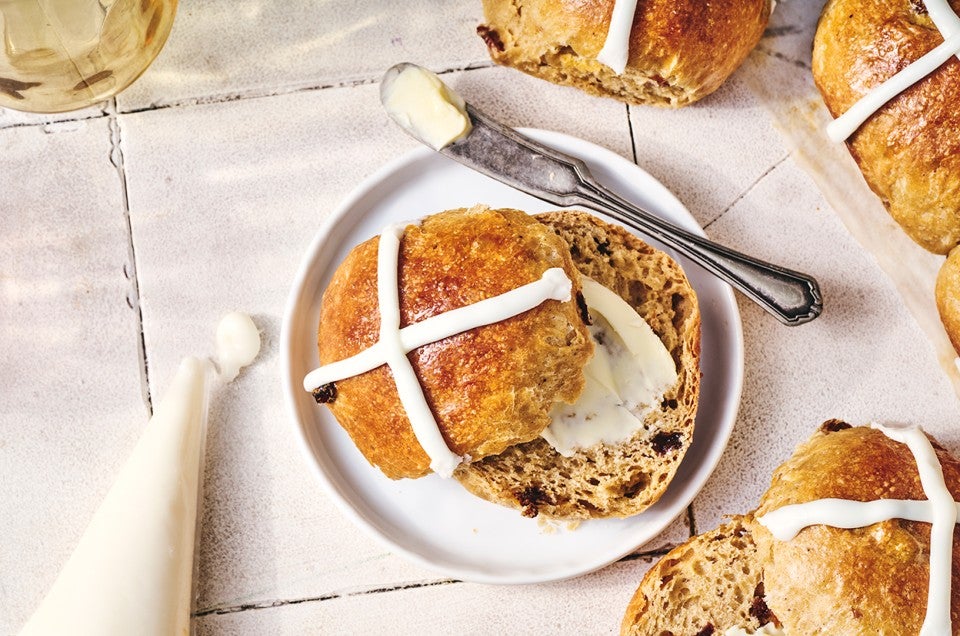 Easy Hot Cross Buns on a plate with butter - select to zoom