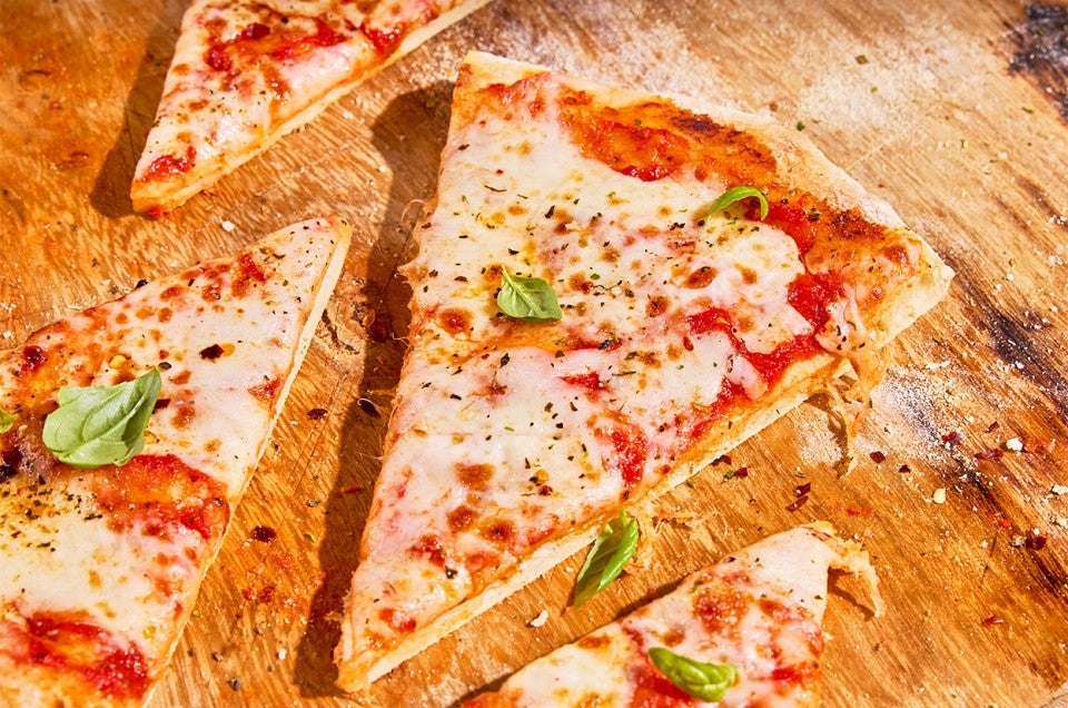 Slices of No-Knead Pizza Crust on a cutting board - select to zoom