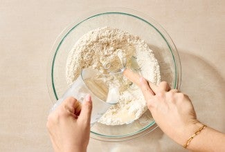 Boiling water being poured into flour