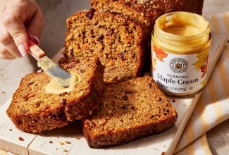 Maple cream being spread on quick bread