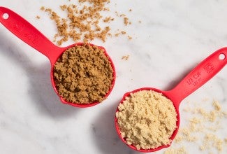 Measuring cups with light and dark brown sugar