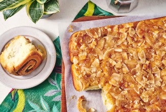 Pineapple Upside-Down Rolls on parchment with one roll out