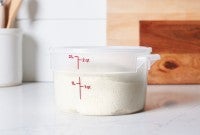 Bread dough rising in a dough proofing bucket