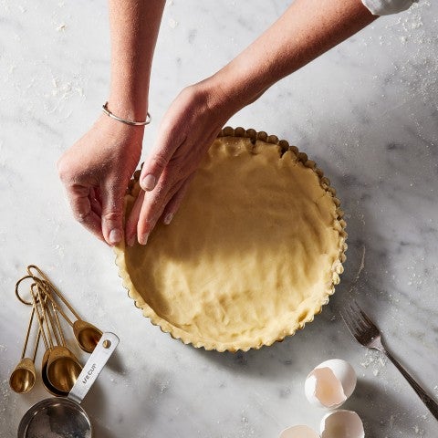 Tart crust being pressed into pan - select to zoom