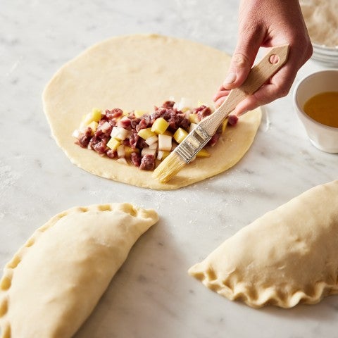 Cornish pasties being assembled - select to zoom