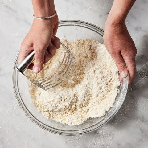 Cutting fat into dry pie crust ingredients - select to zoom