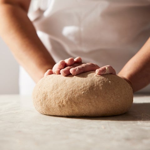 Whole wheat bread dough being kneaded - select to zoom