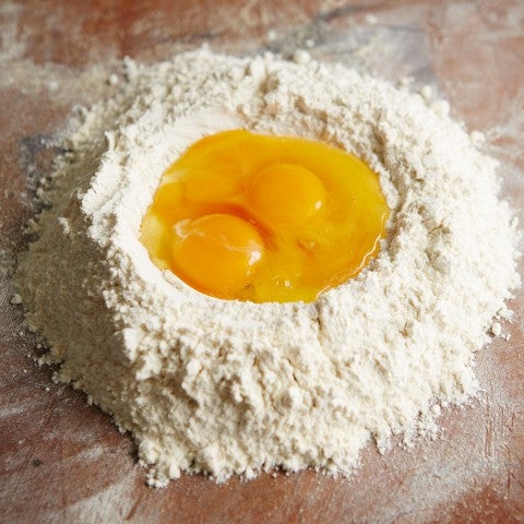 Dry ingredients for pasta with eggs to be mixed - select to zoom