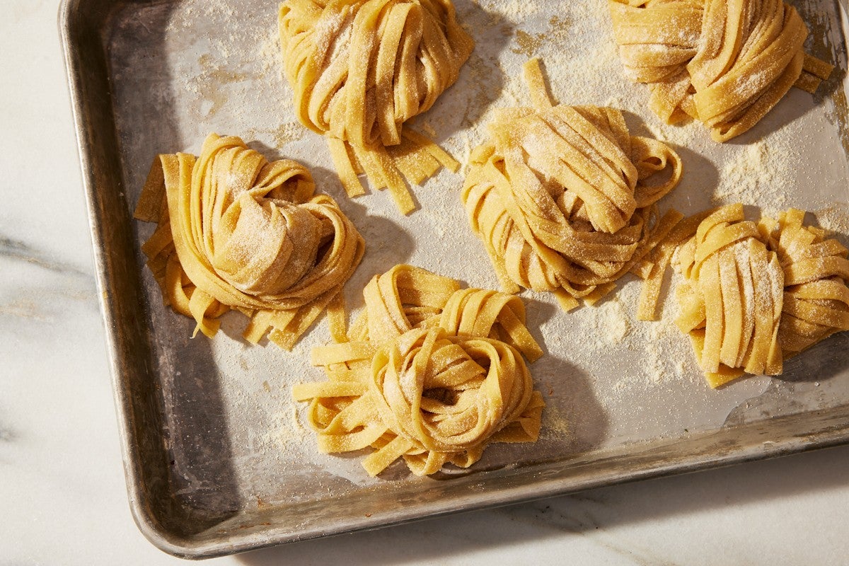 Nests of semolina flour on a baking sheet, ready to cook