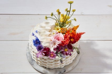 White Wedding Cake With Basket Weave Frosting and Lily Flowers on Top Stock  Photo - Alamy