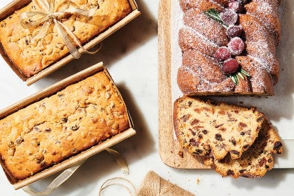 Sour Cream Fruitcake on cutting board and in paper baking pans