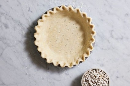 Pie dough in pan with crimped edge