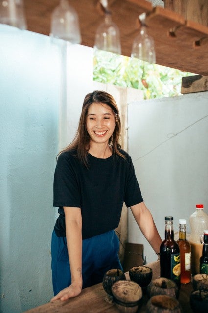 Jessica standing at a table full of drink bottles