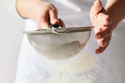 Sifting flour with a sieve