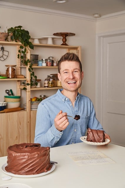 Dan eating a slice of chocolate cake