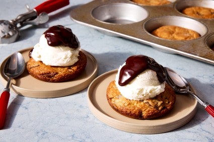 Supersized, Super-Soft Chocolate Chip Cookies turned into an ice cream sundae with hot fudge sauce