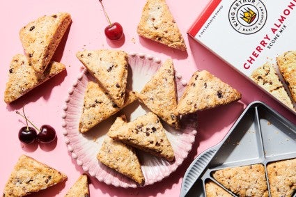 Box of scone mix next to plate of scones and scone pan