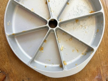 Scone pan showing a few easy-to-clean crumbs and drips once the baked scones have been lifted out.