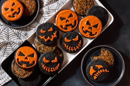 chocolate chip cookies decorated as lanterns on a plate