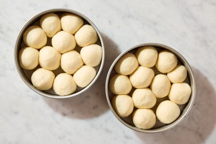 Unbaked rolls in baking pans