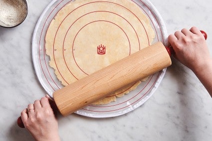 Rolling pin rolling out pie dough