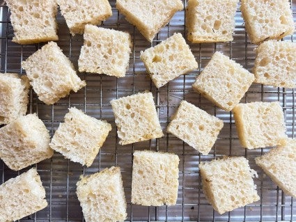 Focaccia diced into squares and set on a wire rack to dry out.