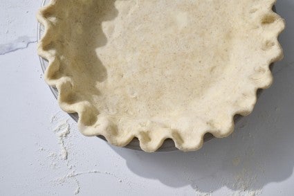 Top with raw pie crust in a pan. 