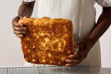 Focaccia lifted to show its crispy bottom