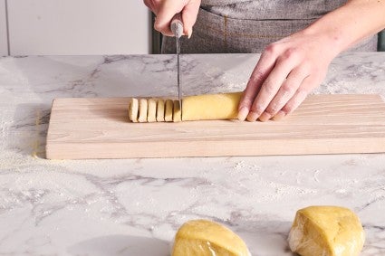 Cutting hand-rolled pasta dough into noodles