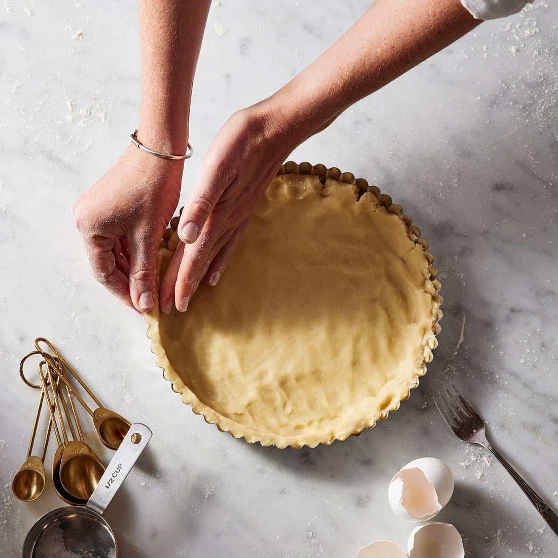 Tart crust being pressed into pan